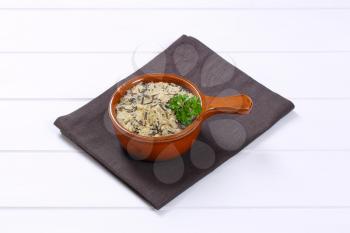 saucepan of wild rice on grey place mat