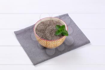 bowl of chia seeds on grey place mat