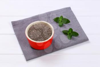 bowl of chia seeds on grey place mat