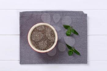 bowl of chia seeds on grey place mat