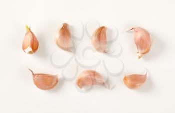cloves of fresh garlic on white background