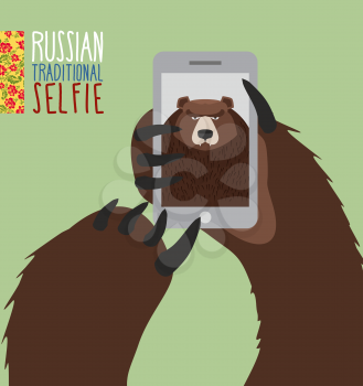 Selfie in Russia. Bear selfie. Bear paw holding a phone. Russian traditional ornament