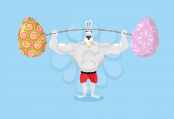 Strong rabbit holding barbell and Easter eggs. Sports for Hare. Traditional Easter egg. Happy Easter. Animal bodybuilder