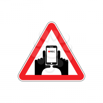 Attention Vertical video. Hand and smartphone to record. Road sign on red triangle. symbol Caution