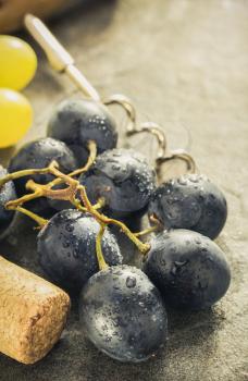 grapes and wine cork on table