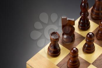 chess figures and board at black background