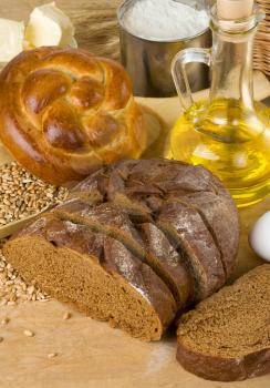 bakery products and grain on wood background