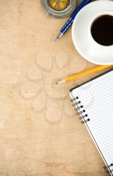 notebook and coffee with compass