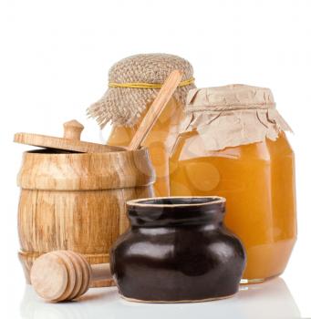 glass, ceramic and wooden jars full of honey isolated on white background