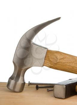 hammer and nail on wood bar isolated on white background