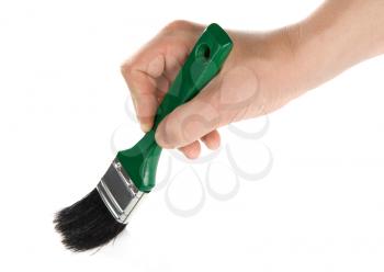 male hand and green brush isolated on white background