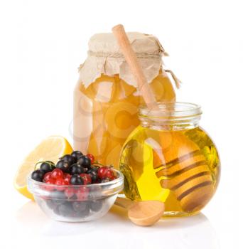 glass jar full of honey and berry isolated on white background