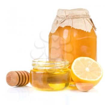 jar full of honey and lemon isolated on white background