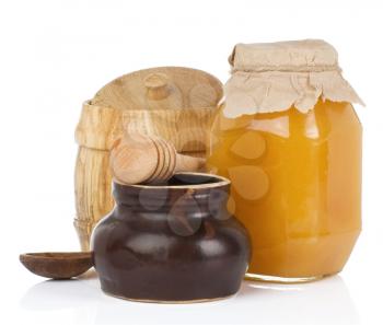 jars and pot full of honey isolated on white background