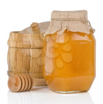 glass and wooden jars full of honey isolated on white background