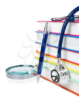 books, pen and stethoscope isolated on white background