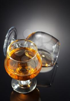 cognac and  glass on black background