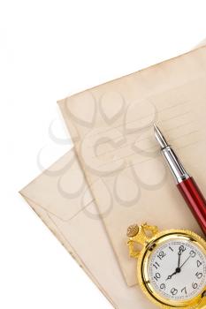 watch and ink pen at vintage envelope isolated on white background