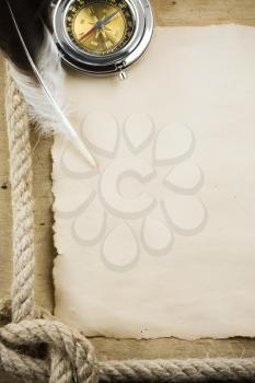 ship ropes and compass on wood background