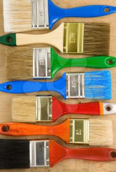 colorful paintbrush on wooden background