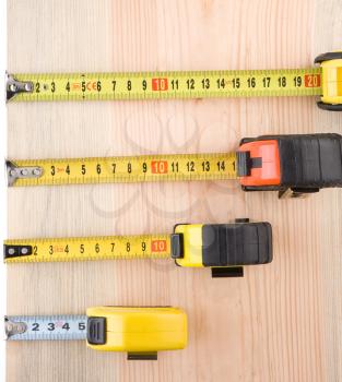 tape measure on wood brick solated at white background