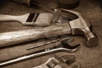 tools and instruments on wood board on sepia