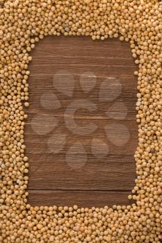 mustard spices on wood background