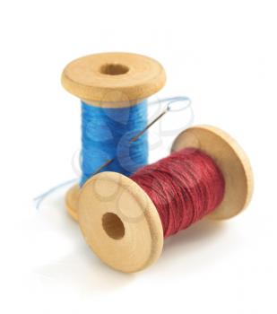 spool of thread and needle isolated on white background
