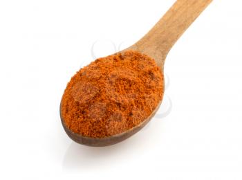 paprika spices in spoon isolated on white background