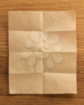 folded note paper on wooden background