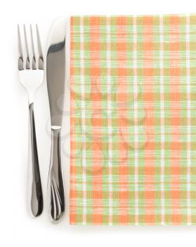 knife and fork at napkin isolated on white background