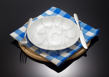 napkin cloth and cutting board on black background