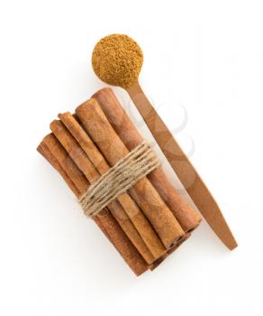 cinnamon sticks and spoon isolated on white background