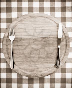 kitchen utensils at cutting board on napkin background