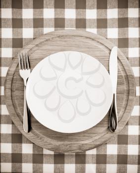 kitchen utensils at cutting board on napkin background