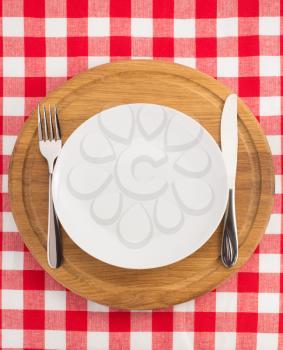 kitchen utensils at cutting board on napkin background