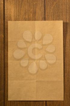 folded note paper on wooden background