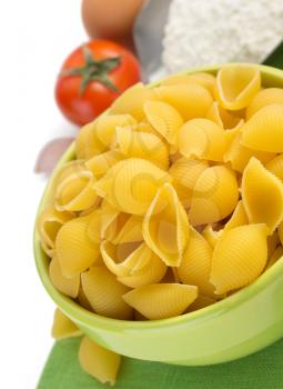 pasta shells in plate isolated on white background