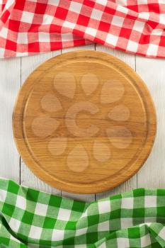 cloth napkin and cutting board on wooden background
