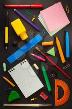 school supplies on black wooden background