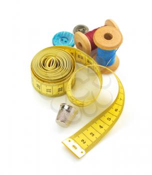sewing tools and measuring tape isolated on white background