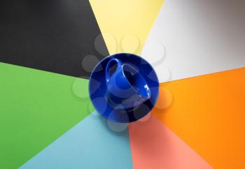 empty cup at colorful paper background