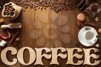 cup of coffee and letters on wooden background