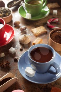 cup of coffee, tea and cacao at table background