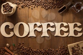 coffee letters and beans on wooden background