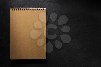 notebook on black background texture