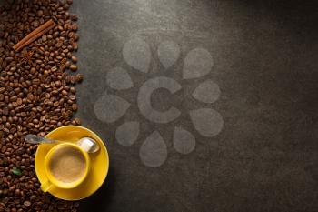 cup of coffee and beans on table background