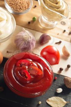 tomato sauce in bowl on wooden background