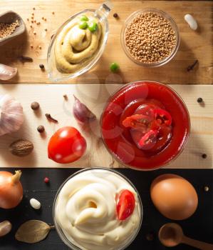 tomato sauce, mayonnaise and mustard in bowl on wooden background