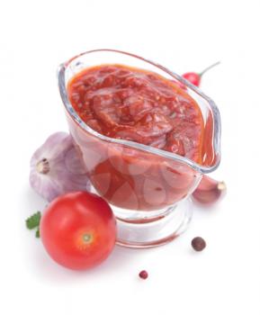 tomato sauce in gravy boat on white background